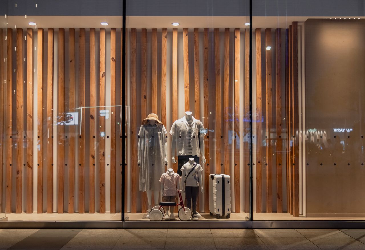 Elegant storefront display with mannequins in fashionable attire, seen in Wuhan, China.